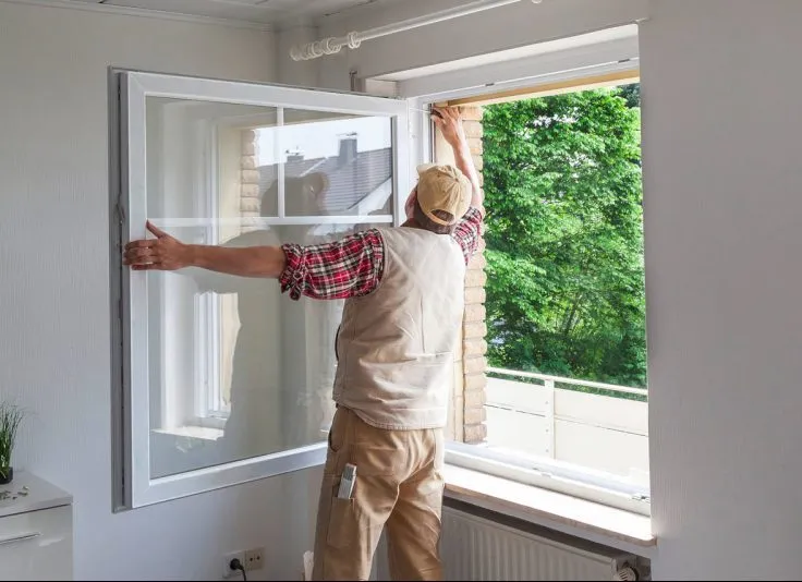 دست در حال باز کردن پنجره دوجداره سفید UPVC